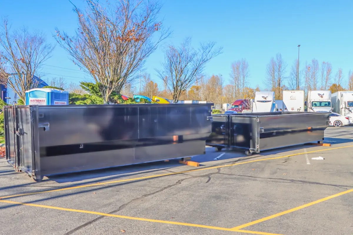 Professional dumpster rental service with roll-off container on residential driveway in Benton Park